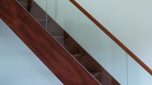 A staircase with glass railings and wooden steps. - Minzu Hotel (Lugu)