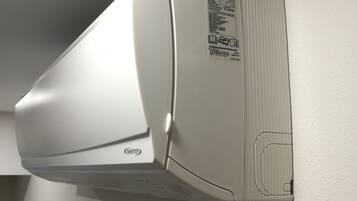 A white air conditioner mounted on a wall.