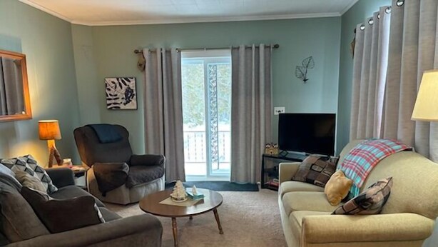 A living room with a sofa, armchair, and a coffee table.