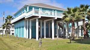 A two-story building with a blue exterior and white balcony railings. - Sum Beach- Great Beach Views-4 bedroom 3 bath home sleeps 13. (Crystal Beach)