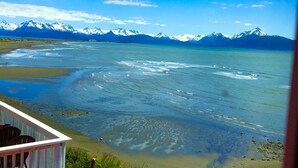 A coastal view with mountains in the background. - Oceanfront Two bedroom Condominium  (Homer)