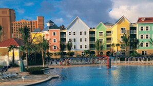 A swimming pool with colorful buildings in the background.