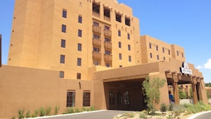A large, multi-story hotel building with a flat roof and a prominent entrance.