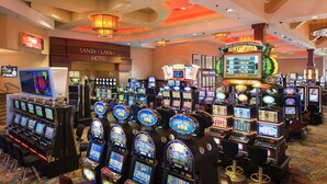 A casino area with multiple slot machines and a 'Beat Field' sign.
