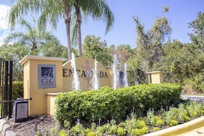 Welcome to Encanto, where lush greenery and a soothing water feature create a serene atmosphere.