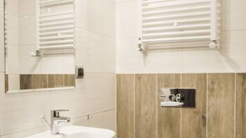 Ein modernes Badezimmer mit Waschbecken, Toilette und Spiegel.