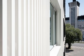 A modern building with large windows and a tree in front. - Hotel Hello Plovdiv (Plovdiv)