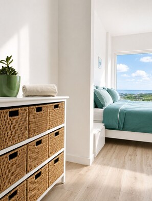 A bedroom with a bed, a potted plant, and wicker storage bins.