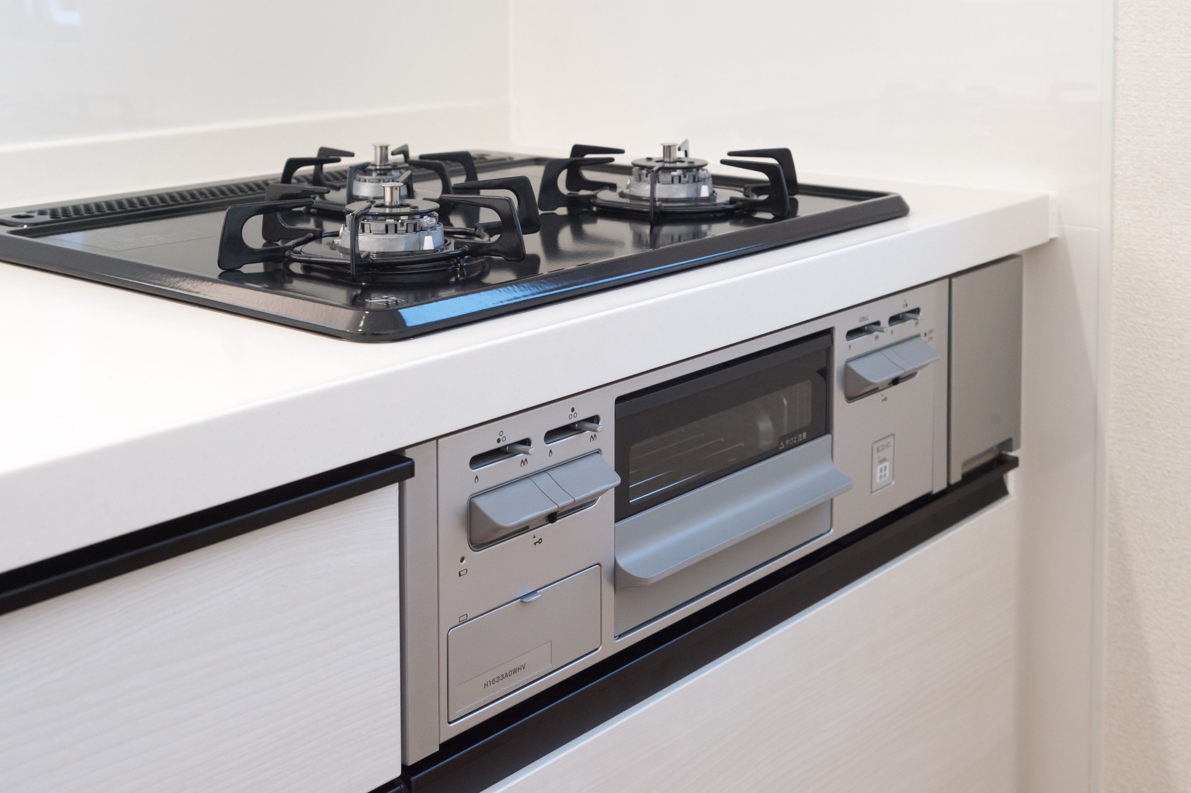 A modern kitchen with a gas stove, oven, and built-in microwave.