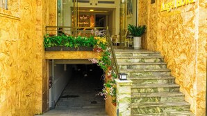 A marble staircase leading to a hotel entrance with a sign reading "Angel Hotel". - Angel Hotel Nha Trang (Nha Trang)