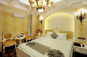 A luxurious hotel room with a large bed, ornate chandelier, and classic decor. - Angel Hotel Nha Trang (Nha Trang)