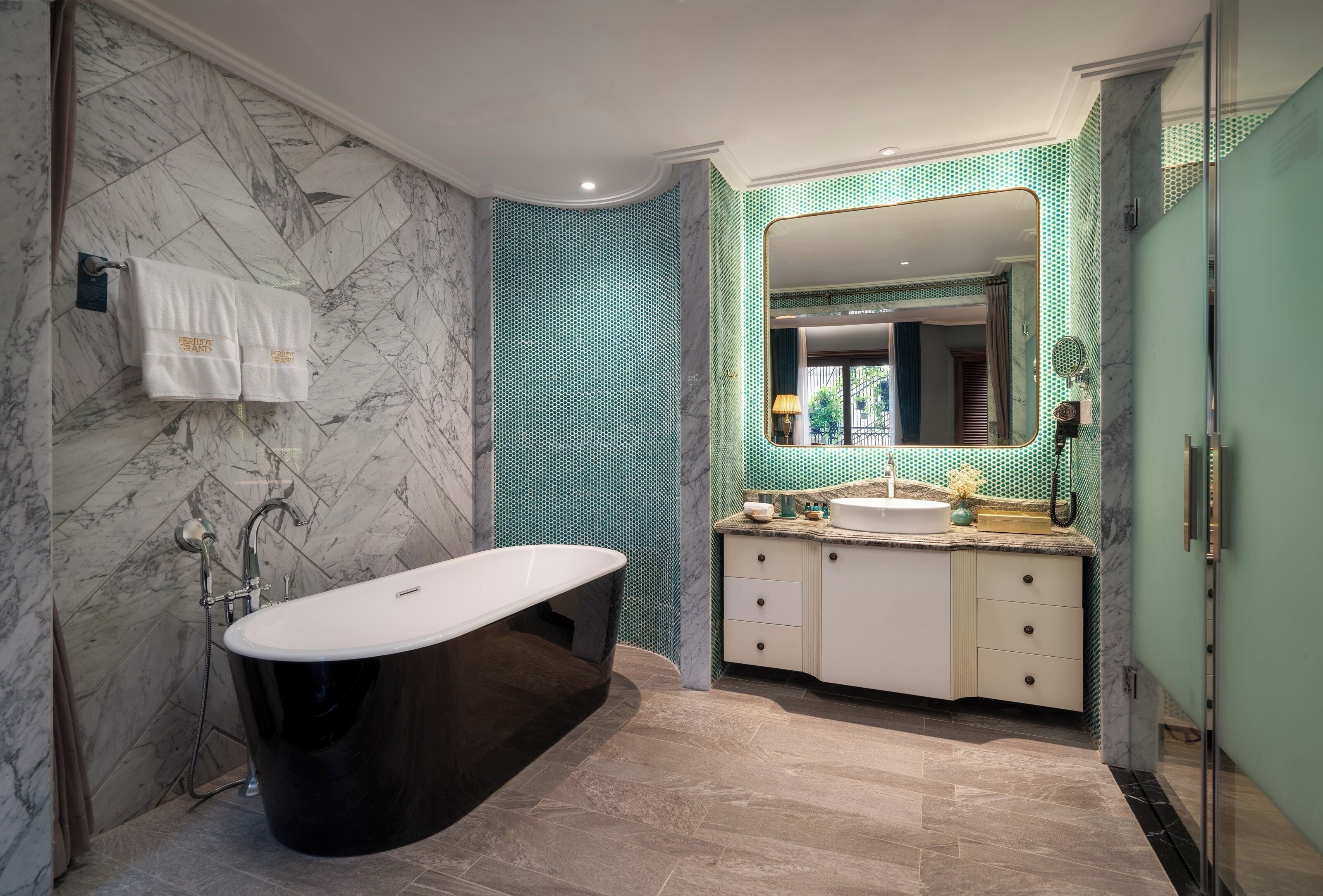 A modern bathroom with a freestanding bathtub, a vanity with a mirror, and a tiled floor.