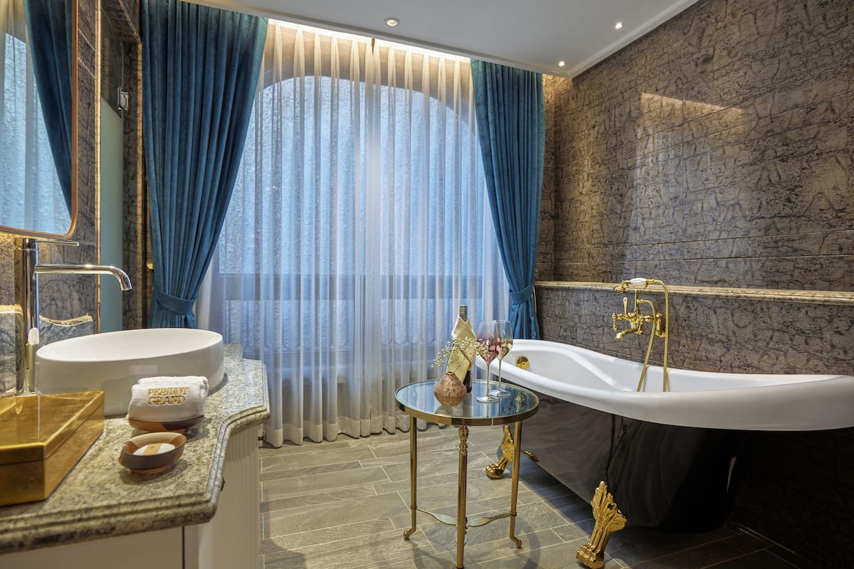 chic deluxe room | bathroom | separate bathtub and shower, deep-soaking bathtub, rainfall showerhead