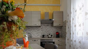 Una cocina moderna con gabinetes de madera, salpicadero de azulejos y una campana extractora de acero inoxidable.