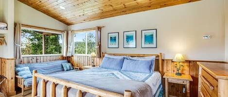 Une chambre à coucher avec un cadre en bois, comprenant un lit, des tables de chevet et une fenêtre.