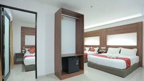 A modern hotel room with a large bed, a wardrobe, a small refrigerator, and a mirror. - Bitz Bintang Hotel (Kuala Lumpur)