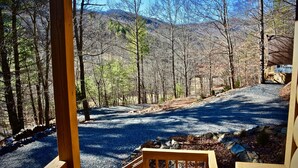 A covered outdoor area with a gravel path leading to a mountain view. - Hot Tub, Views, Romantic Outdoor Lounge Area (Todd)
