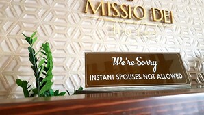 A hotel sign with a geometric pattern and a sign below stating "We're Sorry Instant Spouses Not Allowed". - Missio Dei Hotel (Dipolog)