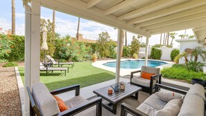 A covered patio area with outdoor furniture, a pool, and a well-maintained garden. - Near Golfing & Shops: Scottsdale Gem w/ Patio! (Scottsdale)