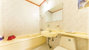 Un baño con bañera, lavabo e inodoro.