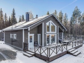 A cabin with a deck, a covered outdoor seating area, and a large window. - Vacation home Kurki by Interhome (Heinola)
