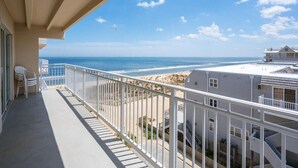 A balcony with a view of the beach and ocean. - Sand Pointe - Oceanfront Escape on 41st Street (Ocean City)