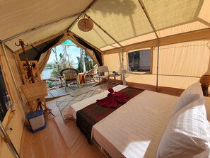 A tented accommodation with a bed, a fan, and a view of the outdoors. - 4k Camp Koh Rong (Koh Rong)