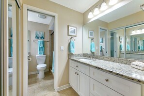 A bathroom with a toilet, sink, and large mirror. - VDP 59 - Relax and enjoy your vacation in this Gold-rated condo overlooking the pool. (Saint Augustine)