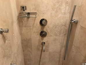 A shower with a handheld showerhead, a wall-mounted faucet, and a handheld showerhead on a glass shelf. - 2 Beds, Fjord Panorama and Pool in Dobrota (Kotor)