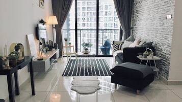 Three-Bedroom Apartment (B-22-02) | Living area | Flat-screen TV