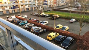 A parking lot with multiple cars parked in rows.