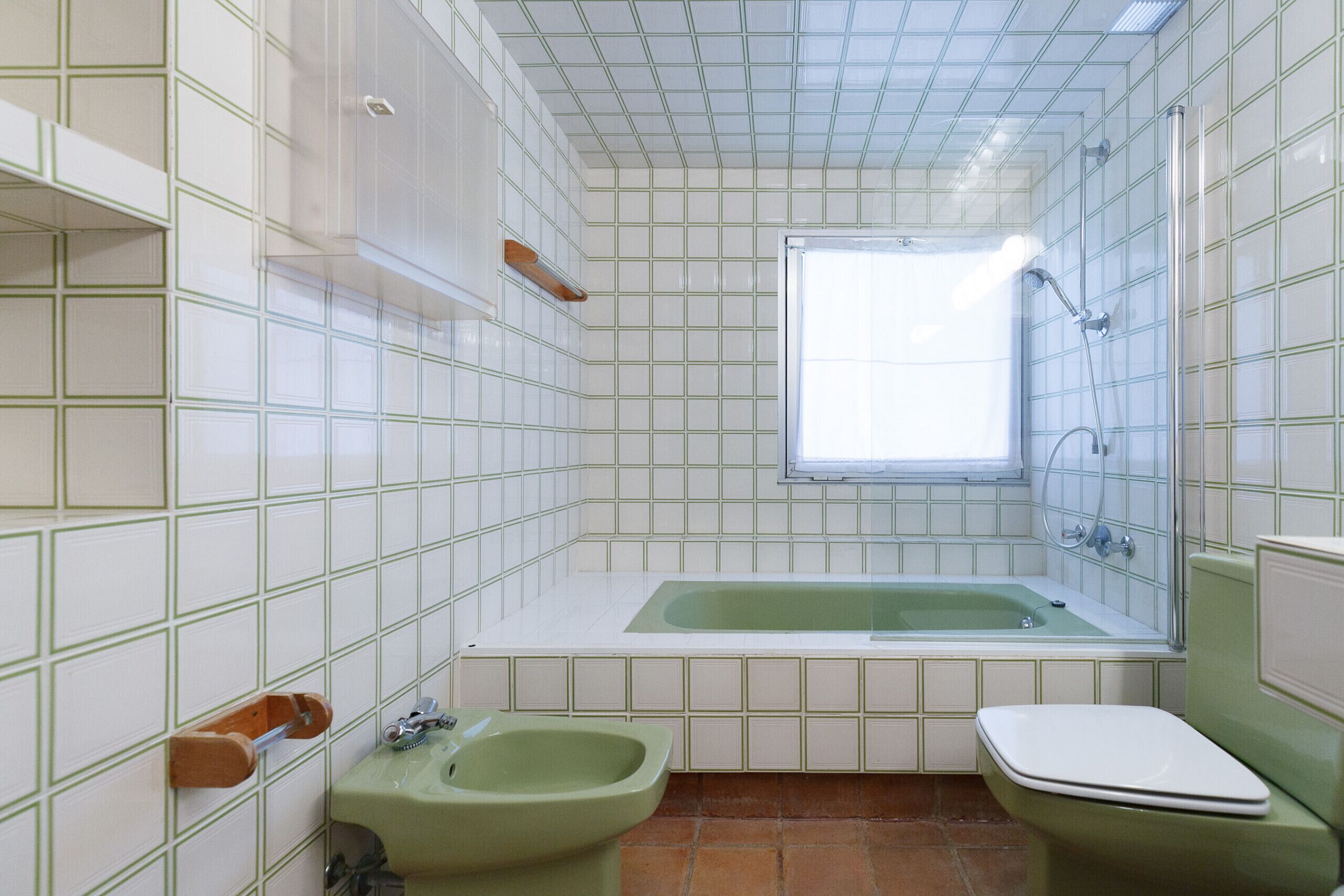 A bathroom with a bathtub, a bidet, and a toilet.