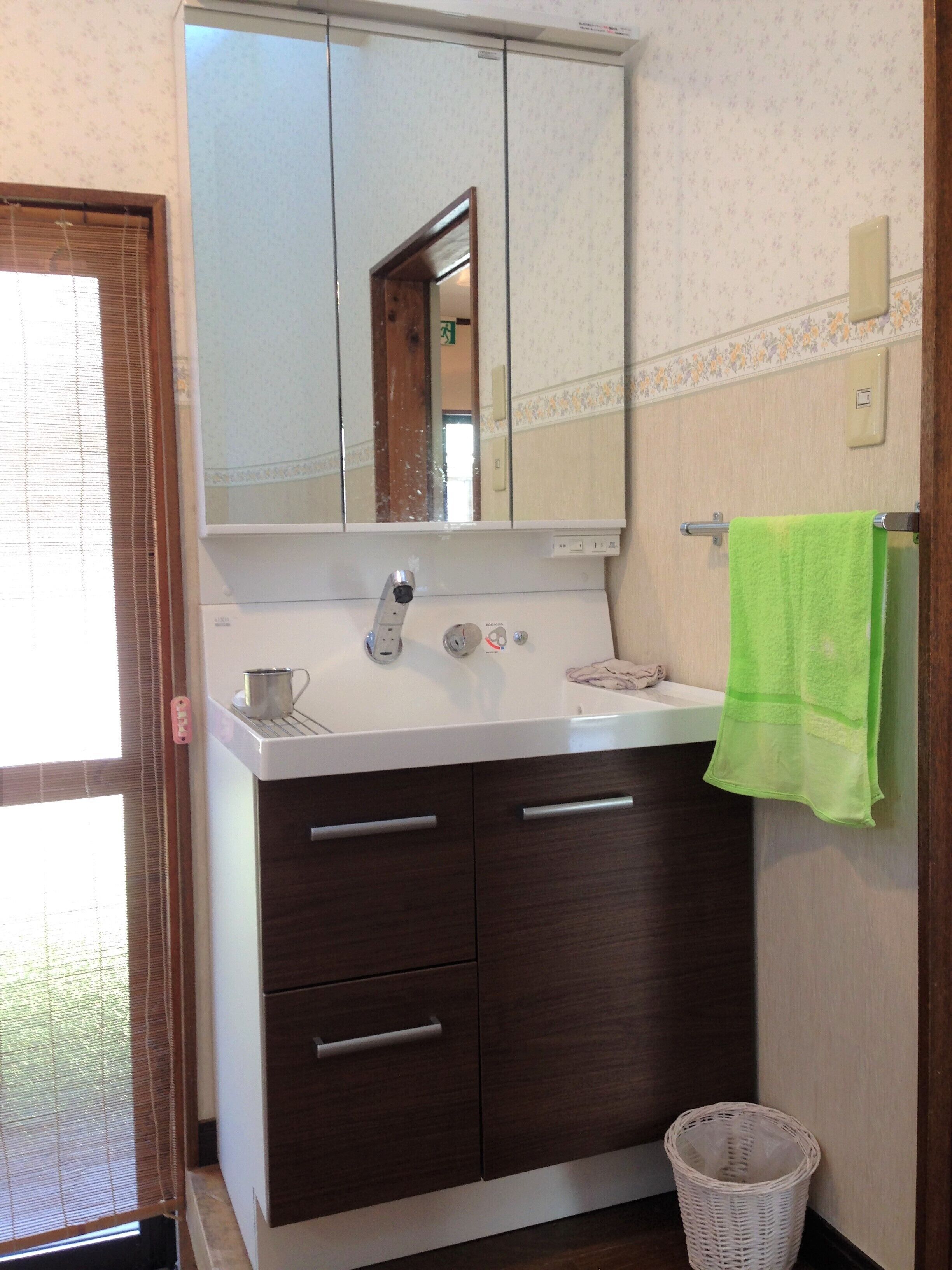 deep-soaking bathtub, rainfall showerhead, hair dryer, slippers