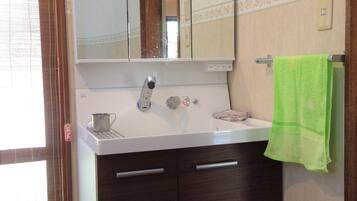 Deep soaking tub, rainfall showerhead, hair dryer, slippers