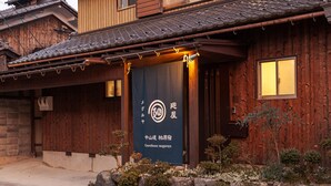 Ein traditionelles japanisches Gebäude mit Holzfassade und Ziegeldach.