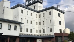A multi-story building with a prominent sign on top. - Business hotel route9 (Matsue)