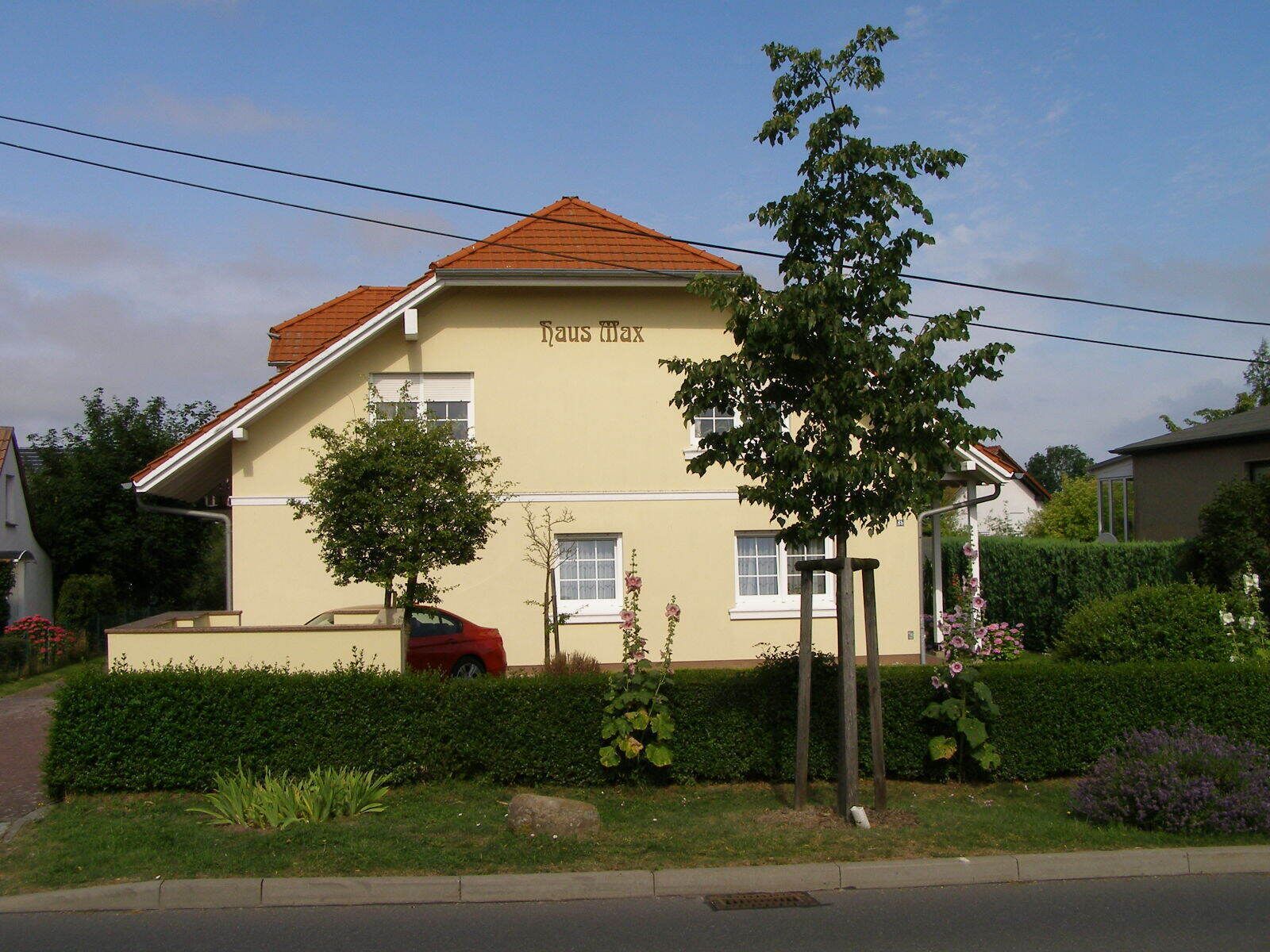 A two-story building with a sign reading "Haus Max".