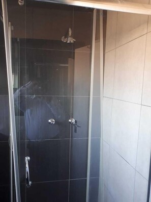 Separate tub and shower, towels, soap, toilet paper