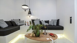 A modern living room with a sofa set, a wooden coffee table, and decorative items. - One Bedroom Apartment, Diadema Apartments Naxos (Naxos)