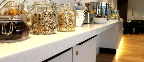 A kitchen counter with various food items and utensils.