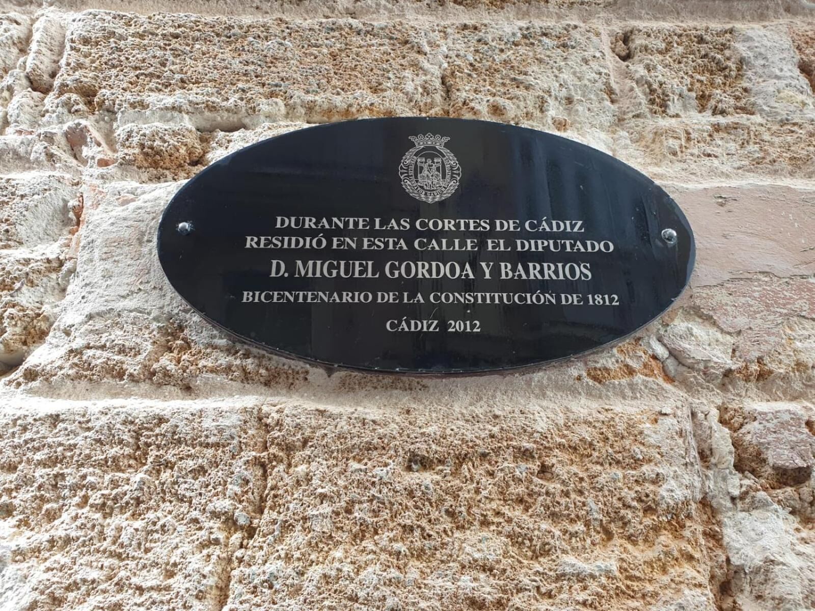 A historical plaque on a stone wall.