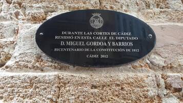 A historical plaque on a stone wall.