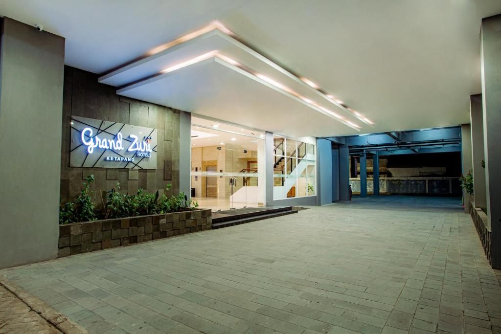 The Grand Zui hotel entrance with a modern design, a visible staircase, and a clear view of the interior.