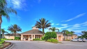 A large, single-story building with a central dome and a covered porch. - Fiji Palms (Kissimmee)