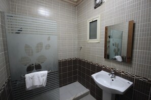 Shower, free toiletries, slippers, towels
