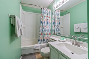 Combined shower/bathtub, towels, toilet paper