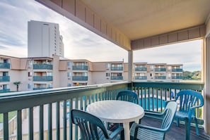 Enjoy the view from this balcony with a round table and four chairs.