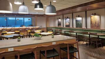 A restaurant with a bar area, booths, and a counter with stools.