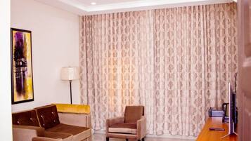 Executive Suite | Living area | 36-inch flat-screen TV with satellite channels, TV