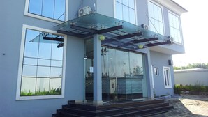 A modern two-story building with large windows and a glass entrance. - Magville Hotel (Lagos)